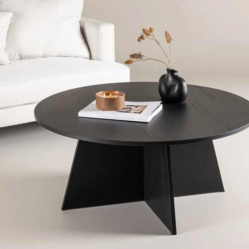 Table basse ronde Bootcut noire sur pied en panneaux croisés, vue de face sur fond blanc