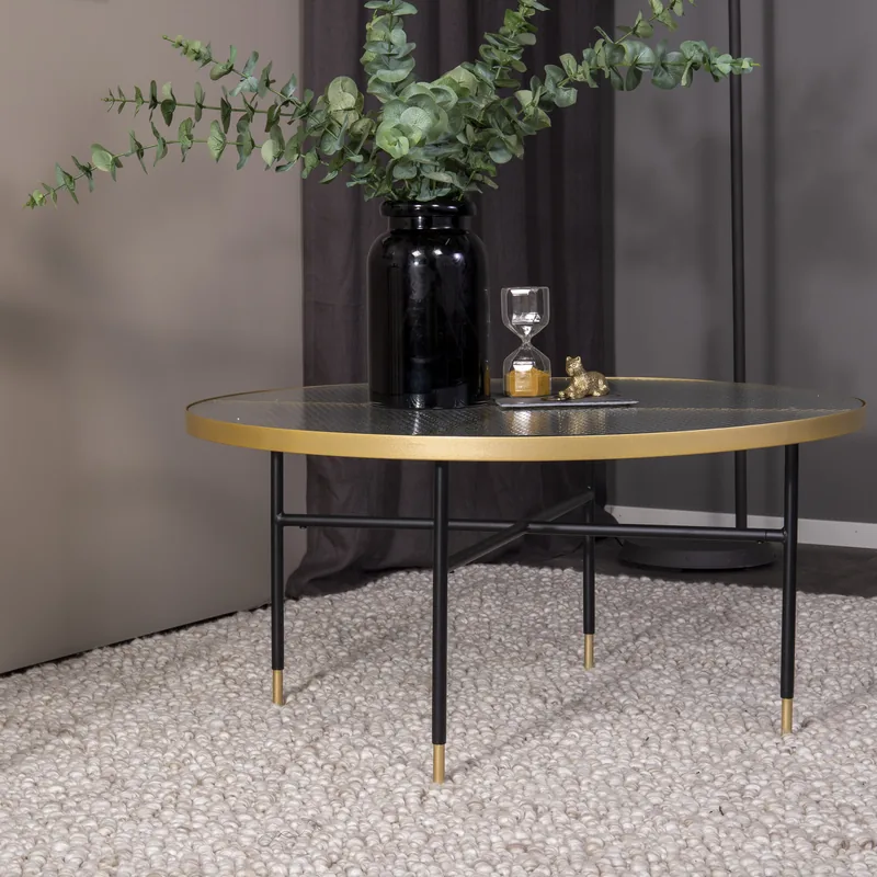 Table basse ronde Bubbles, plateau en verre pressé cerclé de laiton sur pieds noirs à embouts dorés, vue de face