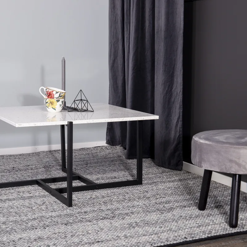 Table basse carrée Hybrid en terrazzo blanc sur piètement noir à barres croisées, vue entière sur fond blanc