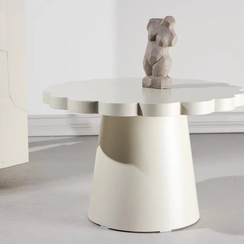 Table basse ronde Krull beige au bord festonné sur pied conique, vue de face