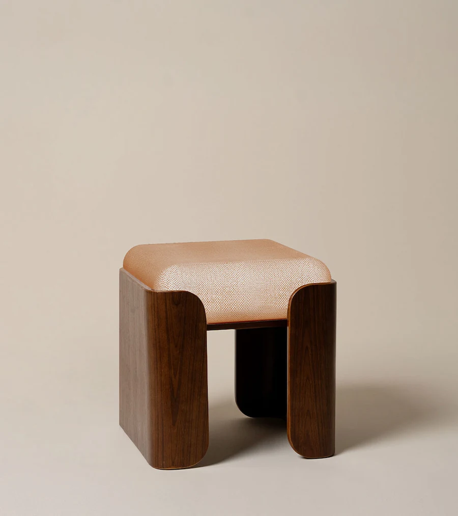 Tabouret Jodie en tissu chiné et bois brun vu de trois quarts, assise carrée sur deux flancs cintrés