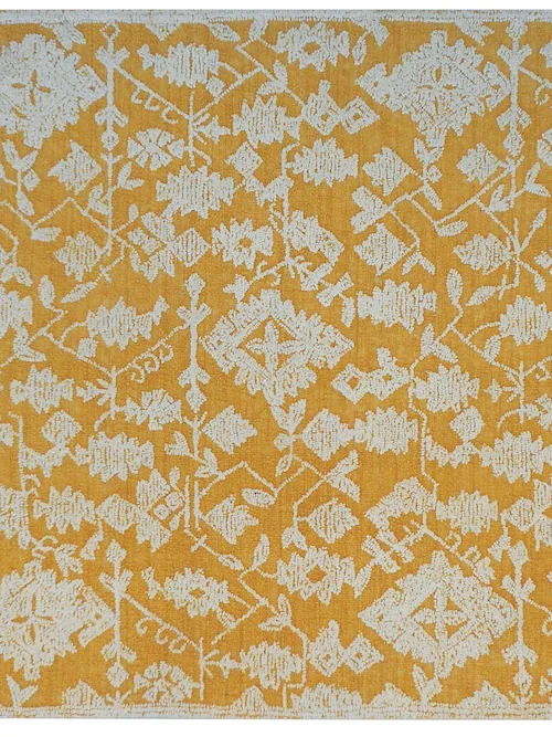 Tapis Reni en laine moutarde à motif ivoire, vu de dessus