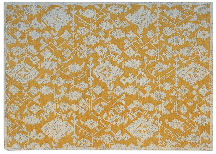 Tapis Reni en laine moutarde à motif ivoire, vu de dessus
